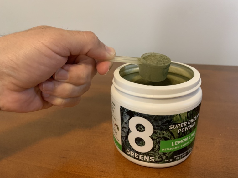 A close look at a scoop of 8Greens Super Greens Powder.