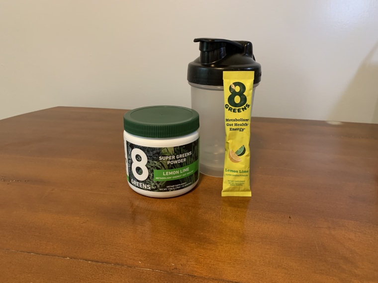 8Greens Super Greens Powder with cup and packet.