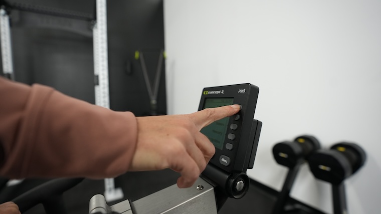 Our tester toggling through the Concept2 BikeErg's LCD center console