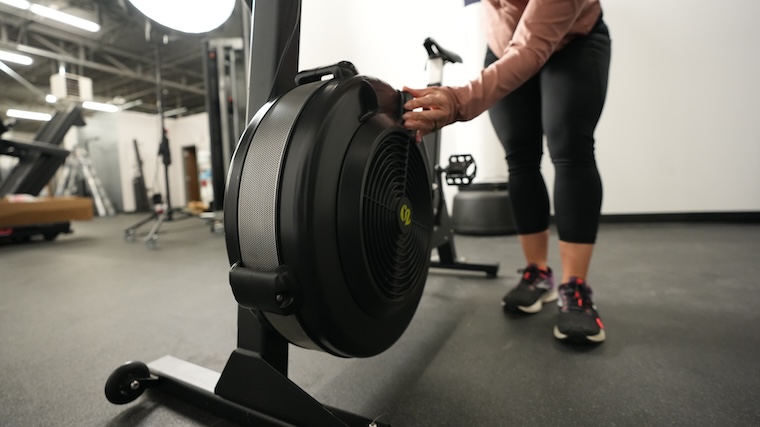 Our tester adjusting the dampener of the Concept2 BikeErg