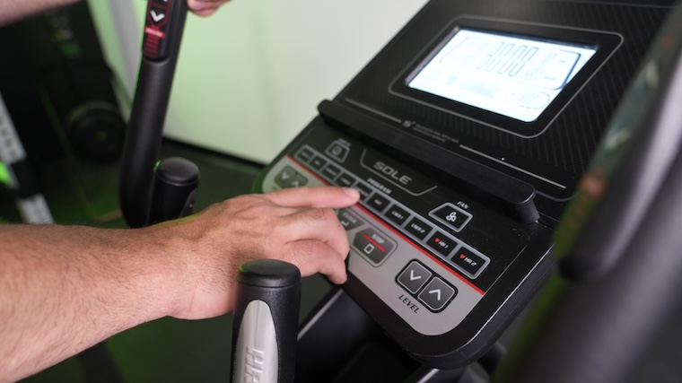 Our tester adjusting the settings of the Sole E25 elliptical