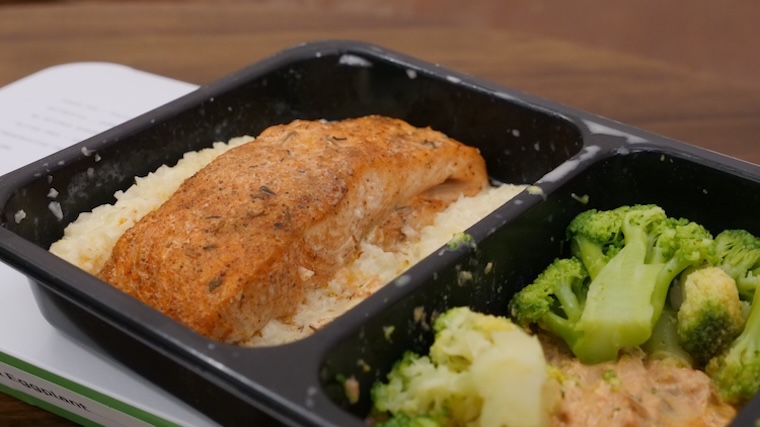 A prepared meal kit featuring fish, rice, and broccoli from Factor Meals