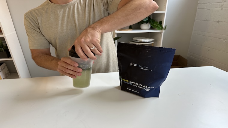 Our tester mixing a shake of Pro Health Longevity Greens