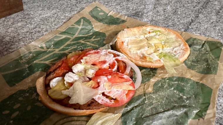 A Burger King Impossible Whopper sits open on its wrapping.