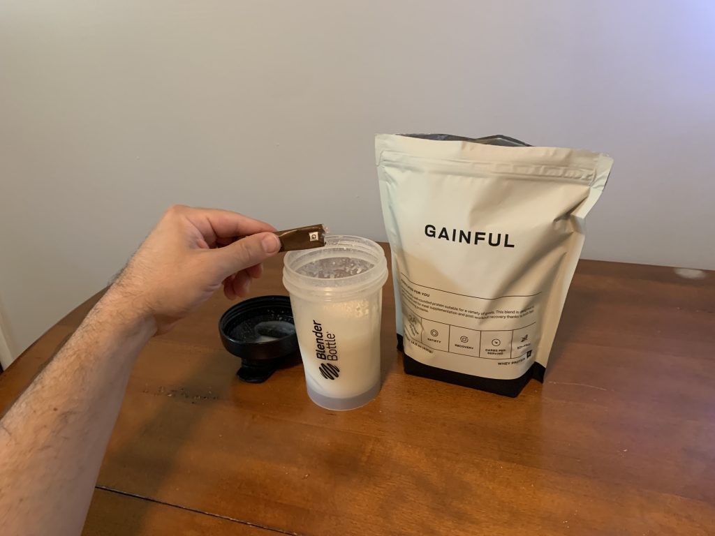 Gainful Protein Powder flavor pack over cup