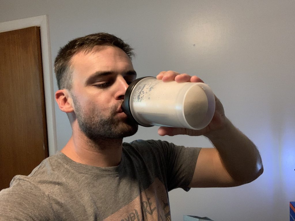 A person sipping a Gainful protein powder shake.