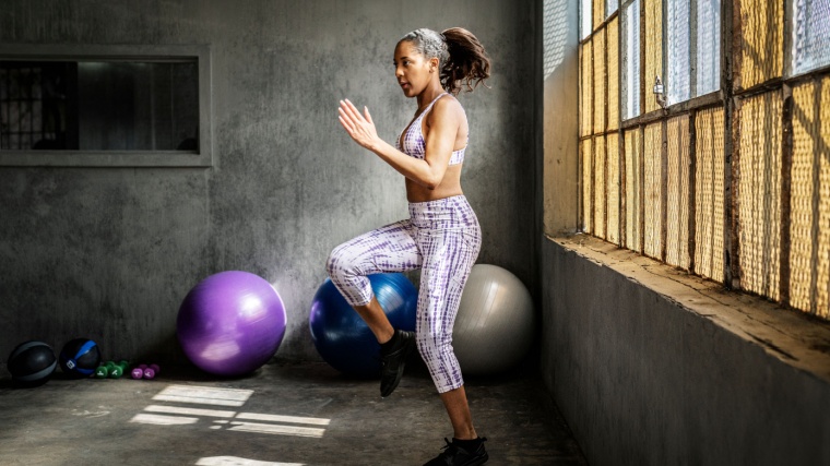 A person performing the high knees exercise.