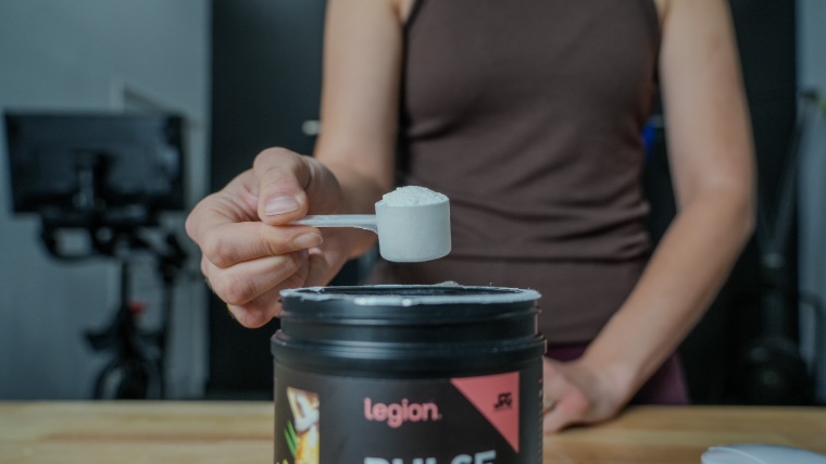 Our tester holds a scoop of Legion Pulse Pre-Workout.