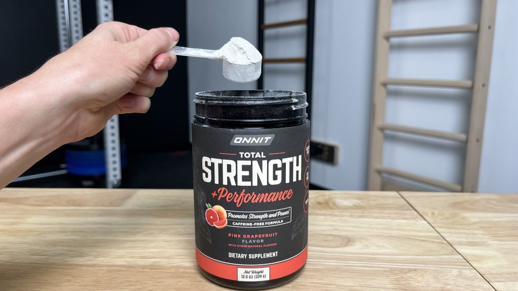BarBend tester scooping Onnit Total Strength & Performance