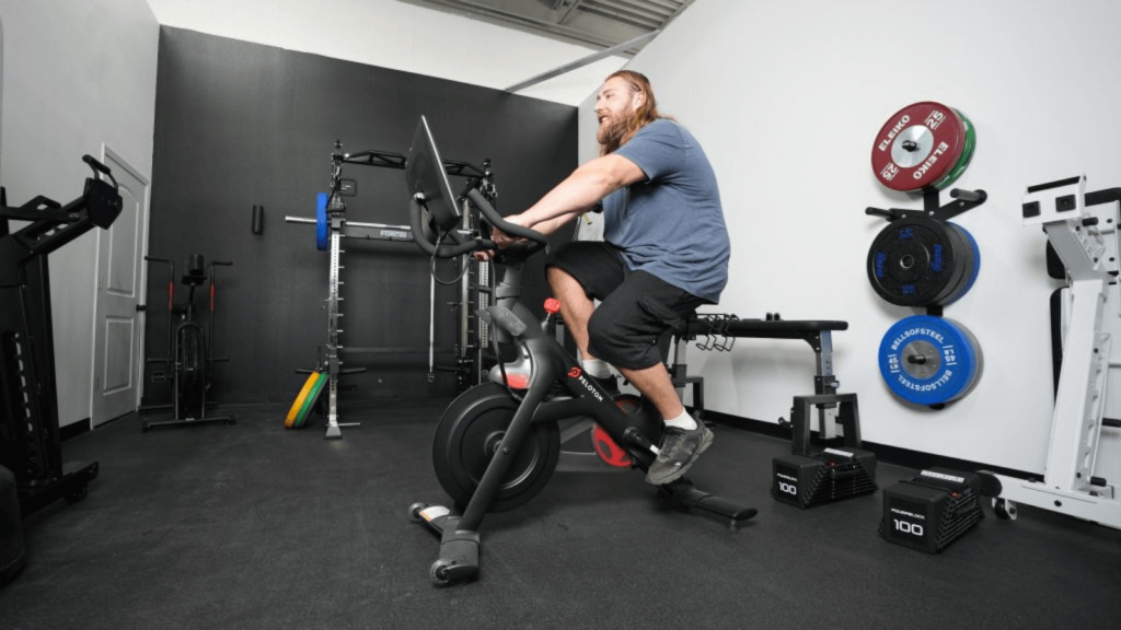 A BarBend tester riding the Peloton Bike.