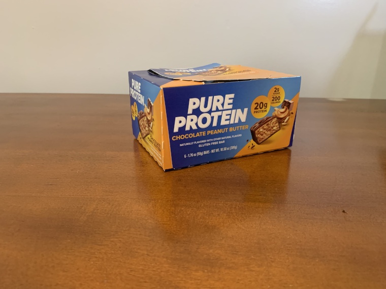 A box of Pure Protein protein bars on a table.