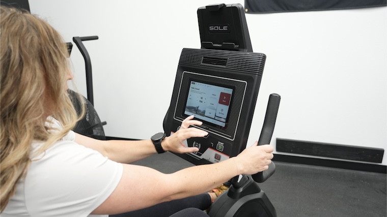 Our tester toggling settings on the Sole LCR Exercise Bike