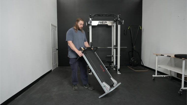 Our tester moving the Sunny Health and Fitness Manual Treadmill.