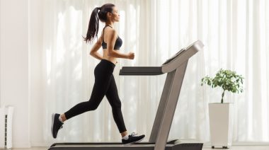 A fit person running on a treadmill.