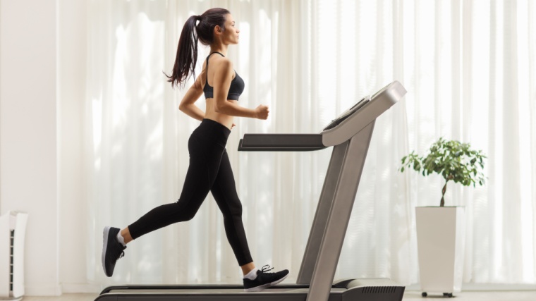 A fit person running on a treadmill.