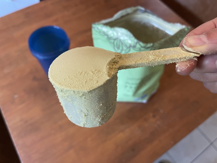 A close look at a scoop of Truvani Plant-Based Protein Powder.