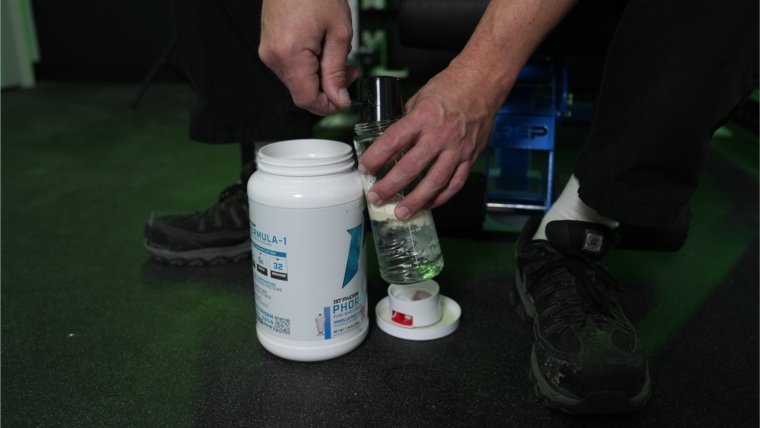 Our tester dumping a scoop of 1st Phorm Phormula 1 Whey Protein