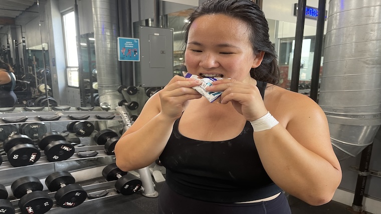 Our tester taking a bite of 1st Phorm Vegan Power Pro Bar