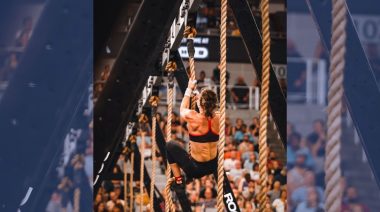 CrossFit athlete climbing rope