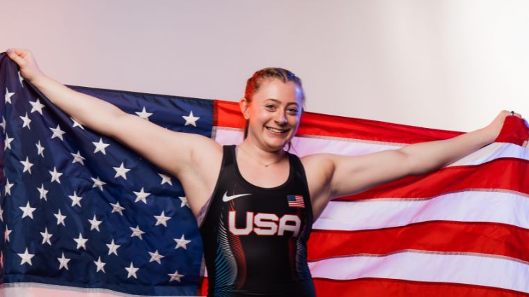 Olivia Reeves brandishes the American flag in her Team USA singlet