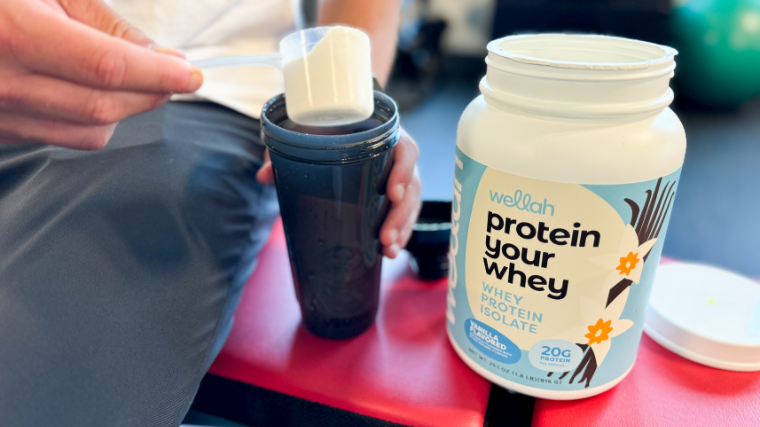 A person scoops Wellah Protein Your Whey.