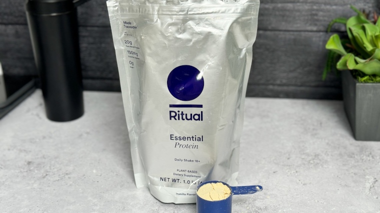 A bag and scoop of Ritual Essential Protein Daily Shake 18+ Protein Powder