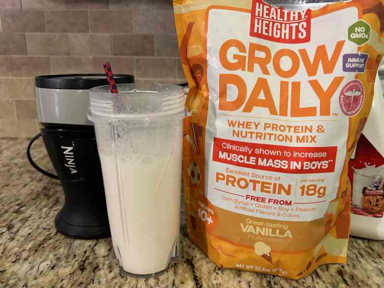 A Healthy Heights Grow Daily Protein Powder shake next to the bag.