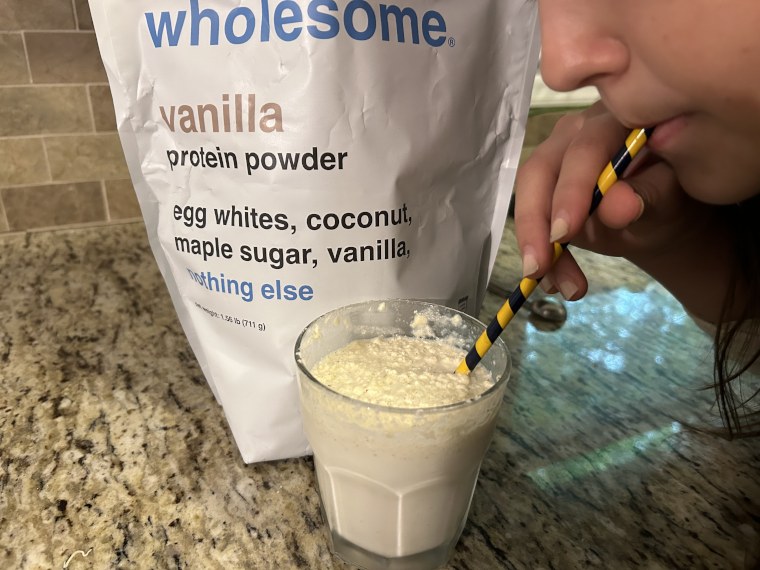 A kid drinks a Drink Wholesome Protein Powder Shake