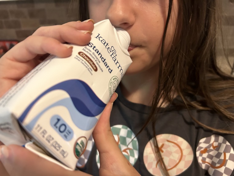 A kid drinks Kate Farms Pediatric Standard.