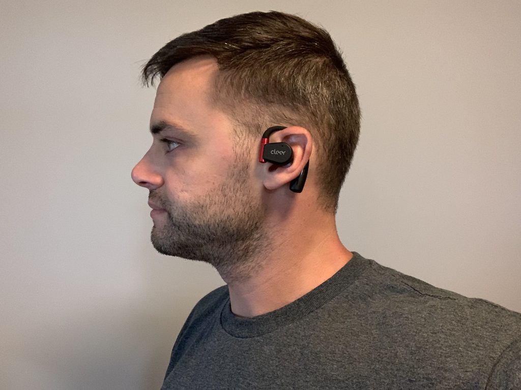 A BarBend tester wearing the Cleer ARC Sport II headphones