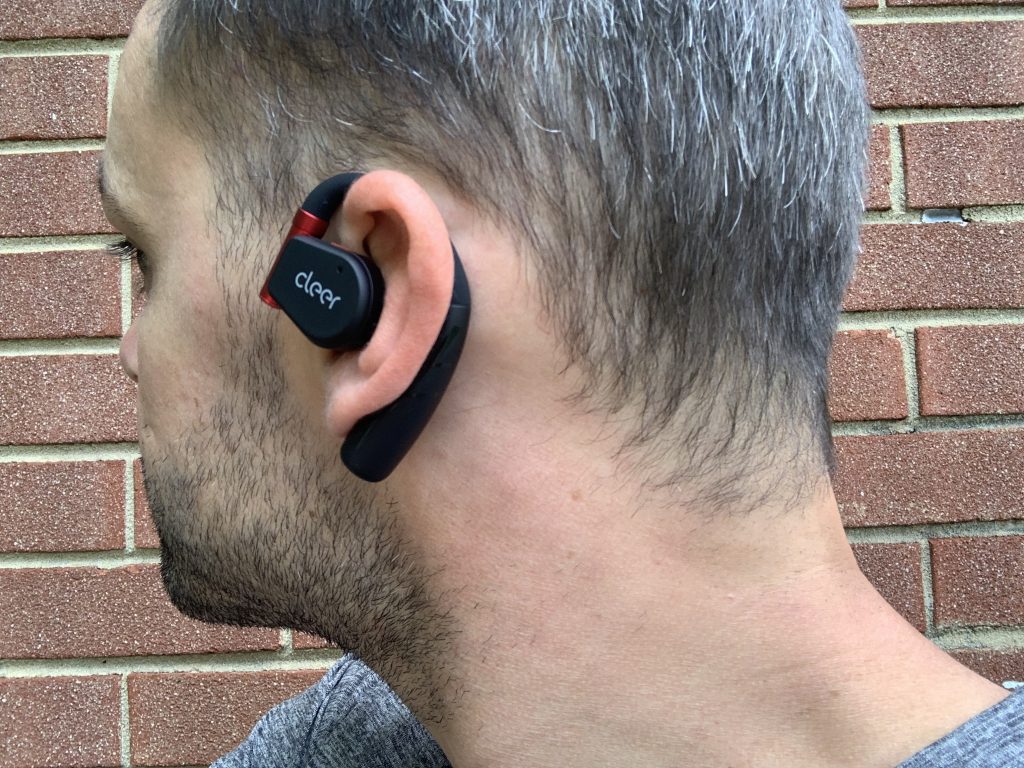 A BarBend tester wearing the Cleer ARC Sport II headphones