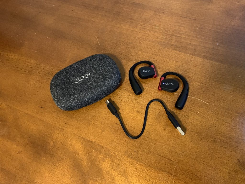 The Cleer ARC Sport II headphones with charger and case