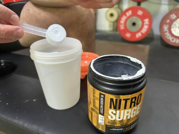 Our tester dumping a scoop of Jacked Factory Nitro Surge.