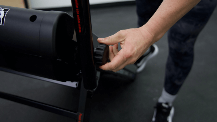 Our tester making adjustments on the Echelon Stair Climber Sport