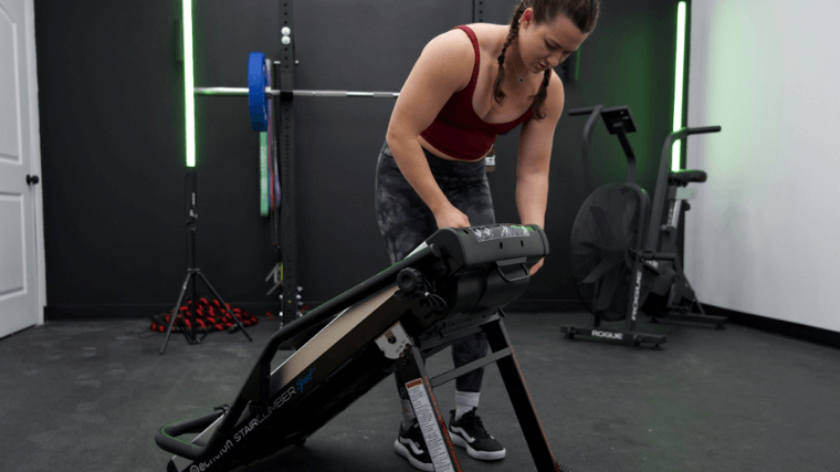 Our tester setting up the Echelon Stair Climber Sport for a workout