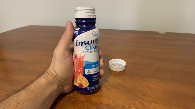 Our tester holds an opened bottle of Ensure Clear