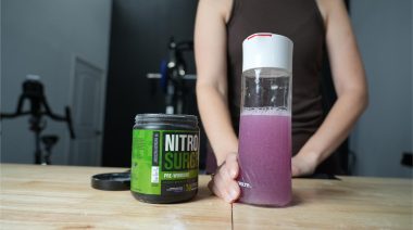 a person holding a serving of Jacked Factory Nitro Surge Pre-Workout