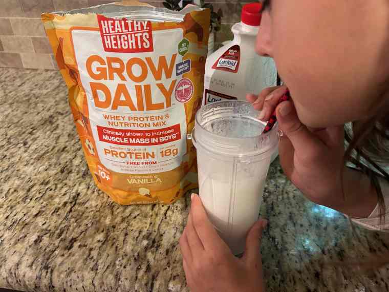 Kid drinks Healthy Heights Grow Daily Protein Powder