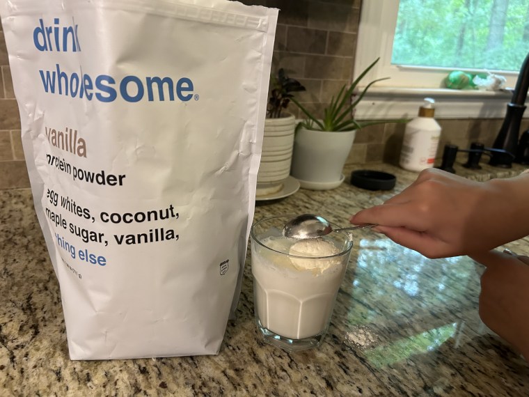 Mixing a serving of Drink Wholesome Protein Powder