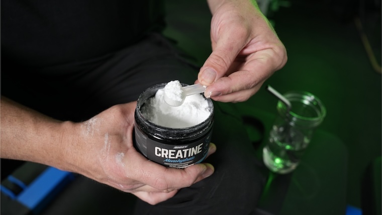 Our tester grabbing a scoop of Onnit Creatine Monohydrate