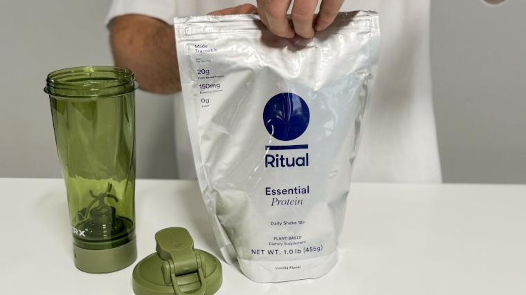 Our tester prepares to open a bag of Ritual Essential Protein 18+ Protein Powder