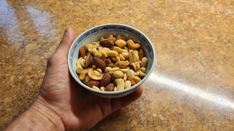 Our tester holds a bowl full of nuts.