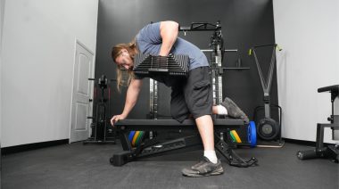 a person using the PowerBlock Adjustable Dumbbell