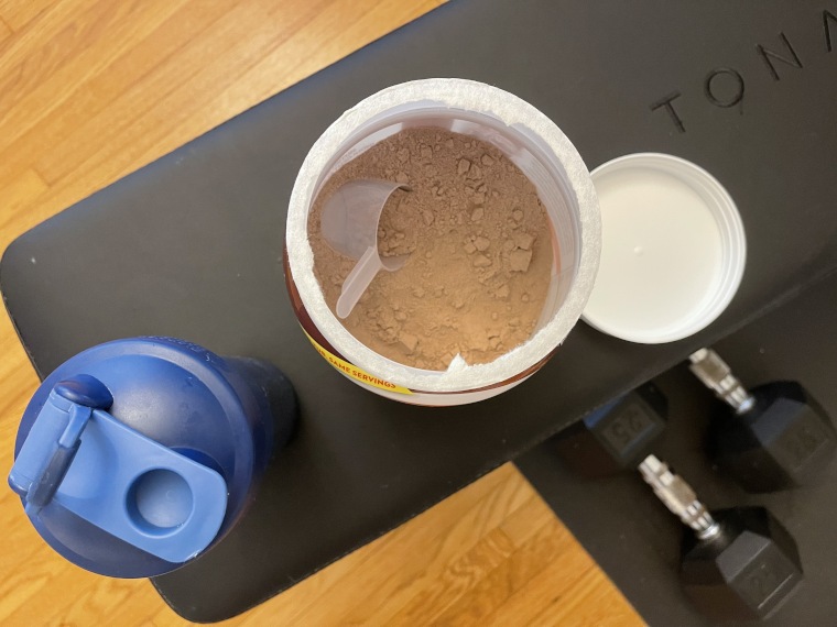 Looking into an opened container of Premier Protein Powder.