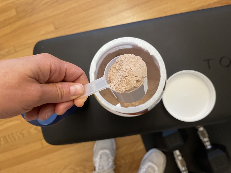 A close look at a scoop of Premier Protein Powder.