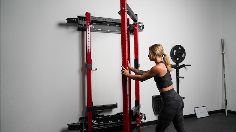 Our tester folds up the PRx Pro Folding Cage after her workout.