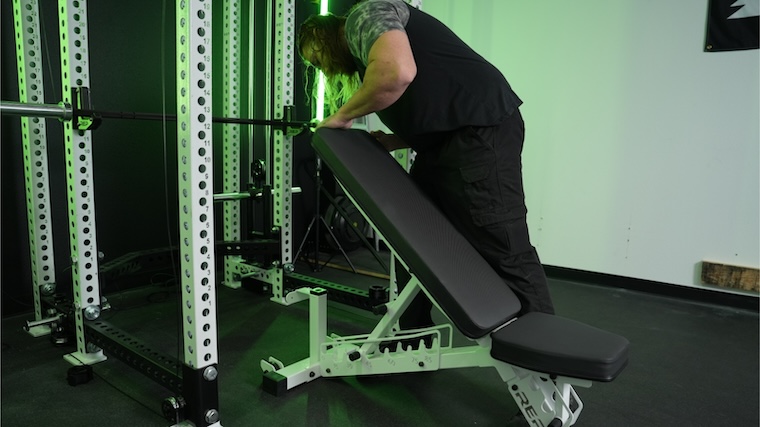 Our tester setting up for a workout with the REP Fitness AB-4100 bench