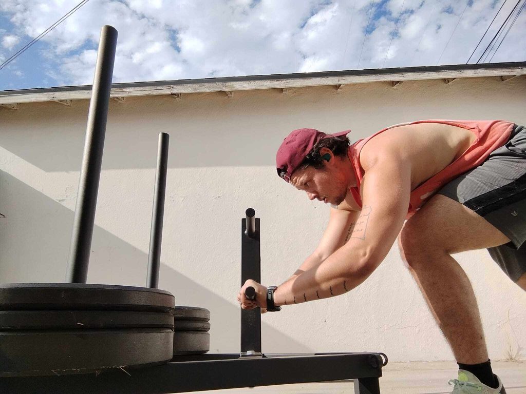 Performing a low push on the REP Fitness Push-Pull Sled.