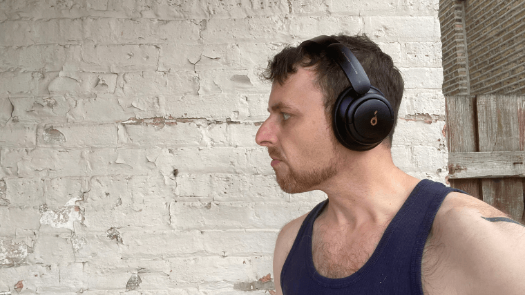 A BarBend tester wearing the Soundcore Q30 over-ear headphones