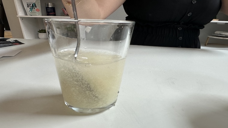 Our tester mixing Sports Research Collagen Peptides in a glass of water